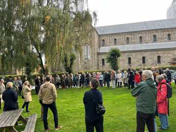 En gruppe voksne personer står ved Viborg Domkirke.